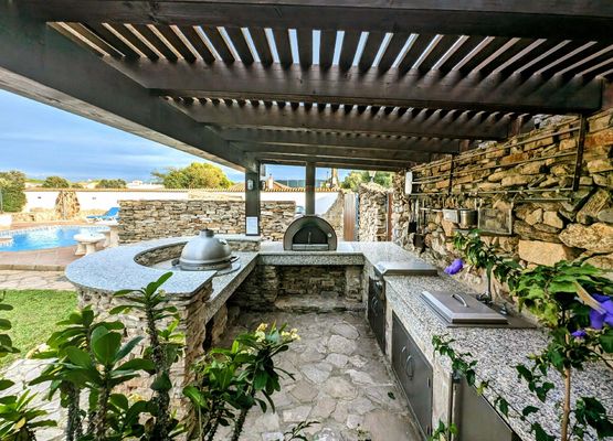 Pergola with garden kitchen, relax bench and ample dining space